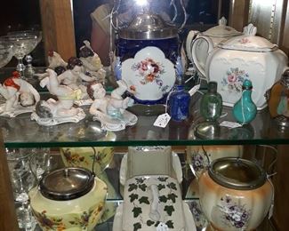 Antique biscuit jars, cheese server, snuff bottles, Rudolf Kammer figurines, and an English teapot.