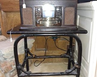 Crosley turntable, CD player, and radio on a painted bamboo table.