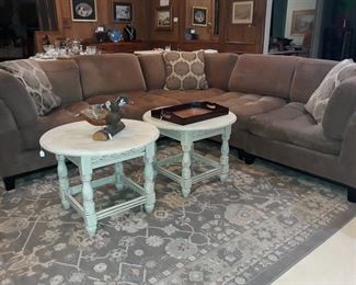 Cindy Crawford sectional sofa, two painted end tables, carved and painted wood ducks mounted on a log, tray, and large area rug.