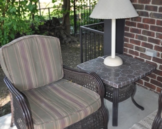 Agio International Company All-Weather Wicker, and Powder-Coated Aluminum Brown Chair with Detachable Cushion. Shown with Agio International Company Table with Stone Top and Olympia Lighting Products Outdoor Table Lamp.