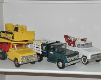 A Fabulous Collection of Vintage Tonka Trucks C. 1950's and 1960's Including a AA Wrecker Truck, Tonka Farms Stake Truck with Horse Trailer and Horses and a Red and Yellow Dump Truck with Trailer and Bulldozer