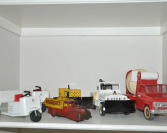 Vintage Tonka Ser-vi-cars, Vintage Tonka Bulldozer, Vintage Tonka Jeep Tow Truck and Vintage Tonka Cement Mixer.   Also Shown is a Vintage Wyandotte Gravel Truck. c. 1930's, 1950's and 1960's