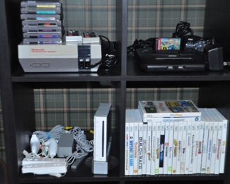 Nintendo Entertainment System with Controllers and Games, Sega Genesis Gaming System with Controllers and One Game, Nintendo Wii Model Number RVL-001 with Controllers.  Also Shown is an Assortment of Nintendo Wii Games Available.