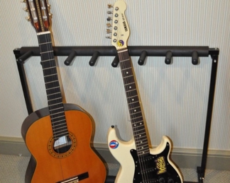 Guitar Stand for Seven Guitars. Shown with a Gould Guita Acoustic Guitar and a Yamaha SE 200 Electric Guitar