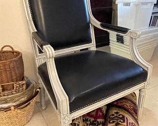 One of two arm chairs covered in Serengeti black leather