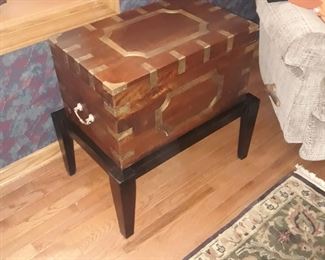 Wood with brass chest on a stand
