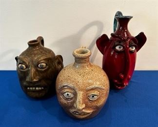 Collection of pottery face jugs