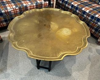 Scalloped top of brass coffee table by Baker