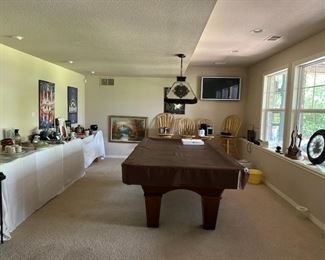 pool table and over haed lamp, wall clocks, bar stools, wall posters, wall pictures and more