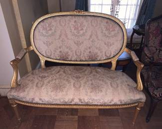 Three piece Louis XVI style parlor suite - canapé and two side chairs, gilt painted with silk floral upholstery.