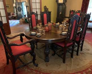 Victorian Renaissance Revival style dark stained carved oak dining table with 5 extensions and 10 chairs