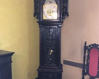 Gothic Revival dark stained carved oak Grandfather clock, attributed to Tiffany & Co., apparently unsigned, last quarter 19th century. Approximately 107 inches