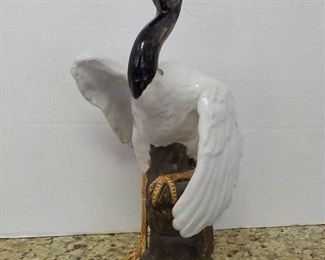 Stately Ceramic Crane Resting On the Rocks