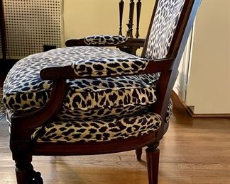 Antique Bergere chair upholstered in Schumacher leopard print fabric with tassel adornments on legs. Measures 26" W x 27"D. Photo 2 of 4.