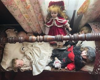 Antique dolls and crib.