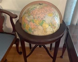 Vintage globe on wooden stand.