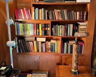 There is a healthy number of books in this sale.  Notice also the torchiere lamp, the LPs, and the lamp on the table.