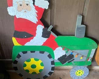 Painted wooden Santa on tractor 