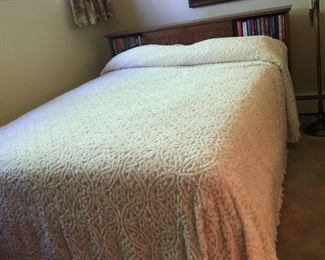 A double bed with headboard that features a great place to stow one’s latest read or favorites. 