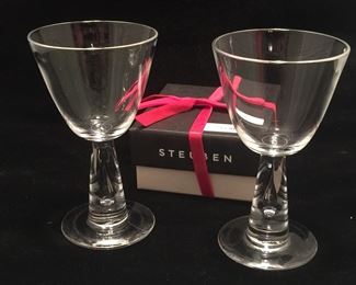 Stemmed glasses by Steuben Glass are unique with an air bubble in the stem. Four glasses are available. 