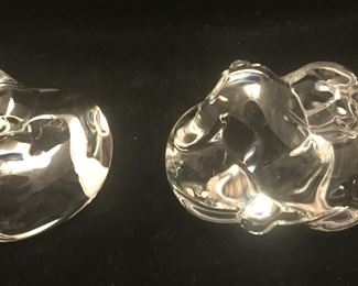 A curled up kitty and nuzzling dogs with one dog facing forward and the other facing backward. 