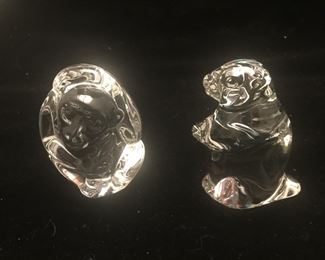 A monkey scratching its head, maybe wondering why the groundhog is so close. 