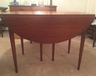 MCM table, 40-by-46 oblong with drop leaves in place. It also has two 16-inch wide leaves and six matching chairs. 
