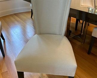 8 white upholstered chairs from Furnitureland South. These will be sold with the dining table as a set. Table + 8 chairs 