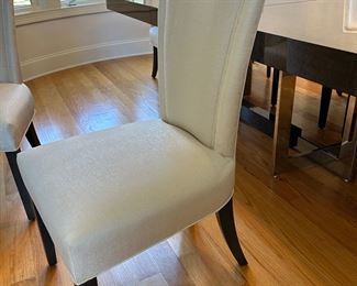 8 white upholstered chairs from Furnitureland South. These will be sold with the dining table as a set. Table + 8 chairs 