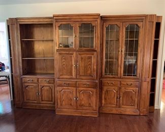 #7	Oak 3 piece Entertainment Center w/ Side Cabinet (Lighted 2 glass shelves) w/Glass Doors Leaded w/1 drawer & 2 doors w/corner Bookcase - 18Dx50Lx81T, Center Entr. 6 doors w/2 leaded glass doors & 2 wood Shelves - 22Dx36x81H   Left Side Cabinet w/1 glass, 1 wood Shelf & 2 doors - 18Dx51Hx81T   You MOve - 	 $275.00 
