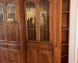 #7	Oak 3 piece Entertainment Center w/ Side Cabinet (Lighted 2 glass shelves) w/Glass Doors Leaded w/1 drawer & 2 doors w/corner Bookcase - 18Dx50Lx81T, Center Entr. 6 doors w/2 leaded glass doors & 2 wood Shelves - 22Dx36x81H   Left Side Cabinet w/1 glass, 1 wood Shelf & 2 doors - 18Dx51Hx81T   You MOve - 	 $275.00 
