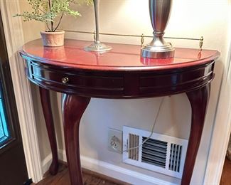 Vintage demilune single drawer console table with brass back rail.