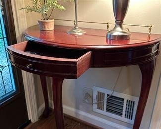 Vintage demilune single drawer console table with brass back rail.