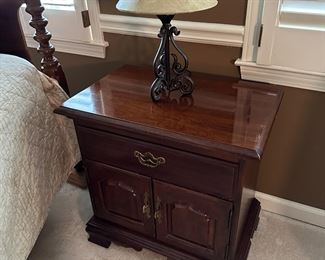 Vintage pair American cherry bedside tables with single drawer over a pair of cupboard drawers.