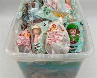 Assorted packaged McDonald's Happy Meal toys including Madame Alexander, Smurfs, Cosmix, SpyBoy