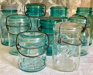 Vintage blue and clear Ball Mason jars with various lids