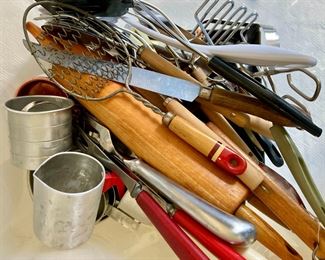Assorted kitchen utensils, measuring cups, flour sifters, mashers, rolling pins, and more