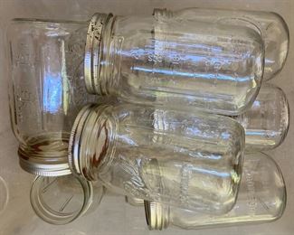 Assorted blue and clear Ball Mason jars with canning lids