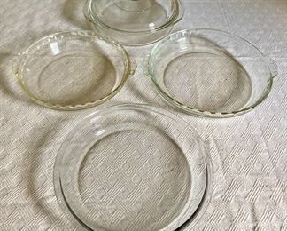 Assorted Pyrex pie plates, round casserole dish with lid