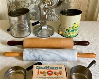 Assorted vintage kitchenware including flour sifters, meat grinders, rolling pins, Revere Ware, canning supplies