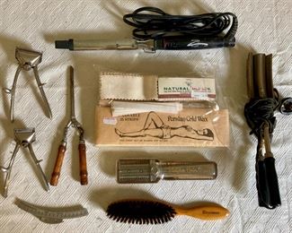 Vintage beauty supplies including curling irons, wave irons, eyelash curlers, waxing strips, brushes and more