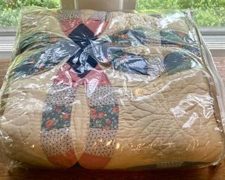 Various quilts, from patchwork and hand-sewn to modern