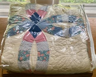 Various quilts, from patchwork and hand-sewn to modern