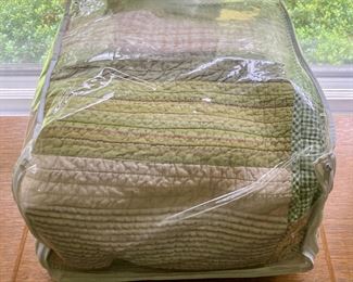 Various quilts, from patchwork and hand-sewn to modern