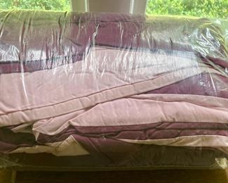 Various quilts, from patchwork and hand-sewn to modern