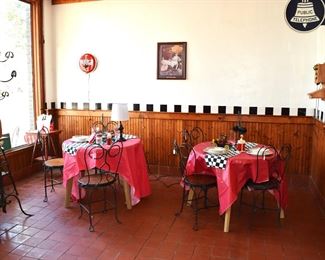 Here are two tables in the dining area, Love the chairs, Love the Neon Coca Cola clock and the cool coat rack