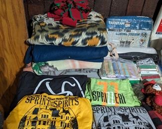 Leftover brand new  t-shirts from the event "Sprint for The Spirits" and a few other promotional pieces of clothing. 