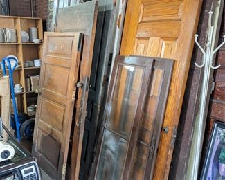 Vintage doors or varying sizes shapes and conditions.