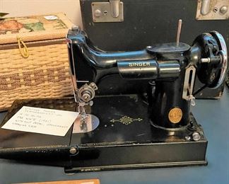 Singer Featherweight sewing machine and attachments. 