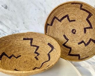 Pair Tutsi Rwanda Woven Plate Basket PAIR African Tribal Art
 Part of an estate collection recently acquired from the heirs, including antique, pre-war pieces, along with various post-1950 items. Please refer to the pictures for condition reports, as each piece shows good, age appropriate surface wear and patina. A few masks are missing the raffia, and exhibit considerable wear. Also notice a few pieces come with museum stands. - Lot 47
